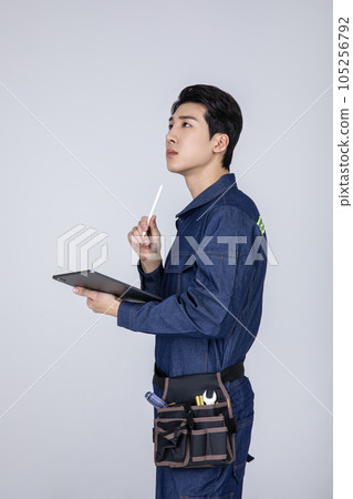 millennials and gen z, korean asian young man, site staff with a tablet pc 105256792