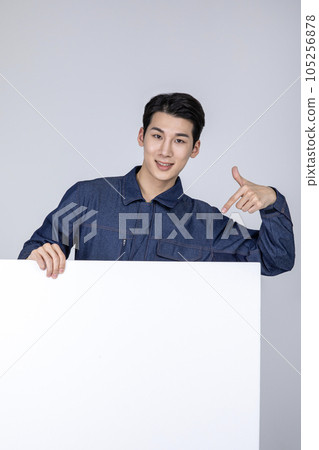 millennials and gen z, korean asian young man, site staff with a frame panel millennials and gen z, korean asian young man, site staff with a frame panel 105256878