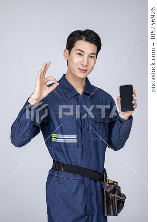 millennials and gen z, korean asian young man, site staff with a smartphone 105256926