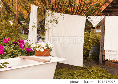 A place for washing and drying clothes, sheets and clothes on the street in the courtyard of a village house. Bathroom in the street courtyard. The concept of autumn 105257097