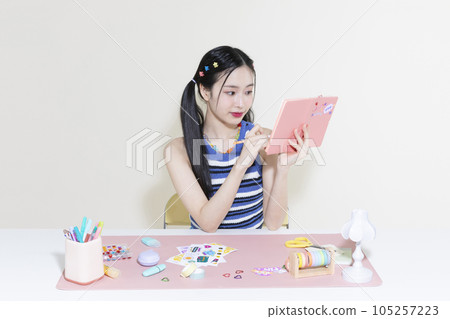 vintage y2k retro concept photo of korean asian cute woman with pen and diary 105257223