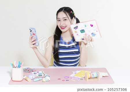 vintage y2k retro concept photo of korean asian cute woman taking selfie of diary decoration with smartphone vintage y2k retro concept photo of korean asian cute woman taking selfie of diary decoration with smartphone 105257306