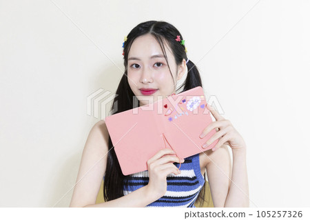 vintage y2k retro concept photo of korean asian cute woman with diary 105257326