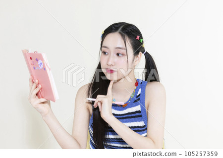 vintage y2k retro concept photo of korean asian cute woman with pen and diary vintage y2k retro concept photo of korean asian cute woman with pen and diary 105257359