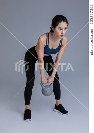 healthy beauty concept photo of korean asian beautiful woman with kettlebell 105257398