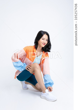 healthy beauty concept photo of korean asian beautiful woman tying shoelaces 105257436