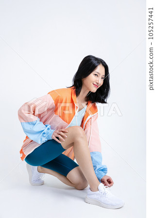healthy beauty concept photo of korean asian beautiful woman tying shoelaces 105257441