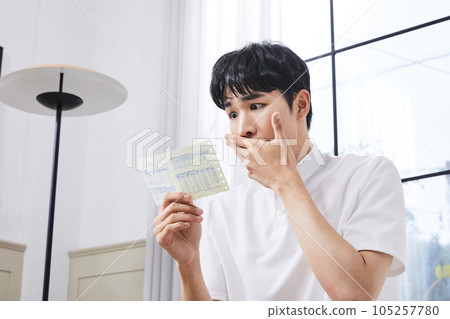 summer lifestyle, korean asian young man surprised by a bill 105257780