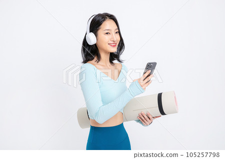 healthy beauty concept photo of korean asian beautiful woman wearing a headphones and listening to music 105257798