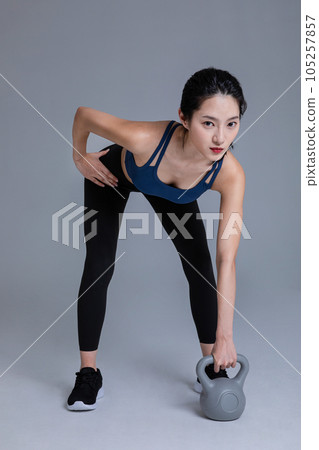 healthy beauty concept photo of korean asian beautiful woman with kettlebell 105257857