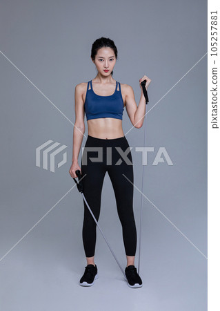 healthy beauty concept photo of korean asian beautiful woman with resistance band 105257881