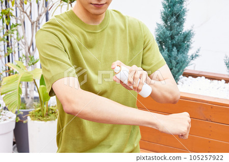 summer lifestyle, korean asian young man with mosquito repellent 105257922
