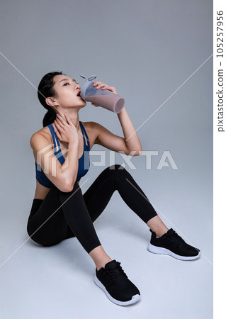 healthy beauty concept photo of korean asian beautiful woman with protein shakes 105257956