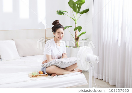 summer lifestyle, korean asian young woman with bed and fan summer lifestyle, korean asian young woman with bed and fan 105257960