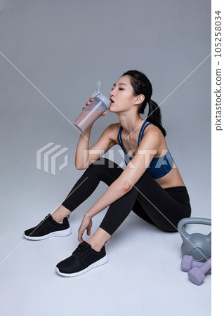 healthy beauty concept photo of korean asian beautiful woman with protein shakes 105258034