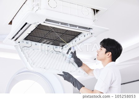 summer lifestyle, korean asian young man cleaning the air conditioner 105258053
