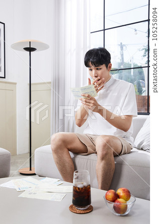 summer lifestyle, korean asian young man surprised by a bill 105258094