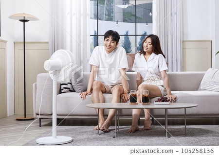 summer lifestyle, korean asian young couple enjoying fan breeze summer lifestyle, korean asian young couple enjoying fan breeze 105258136