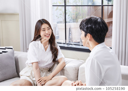 summer lifestyle, korean asian young couple sitting on couch and talking summer lifestyle, korean asian young couple sitting on couch and talking 105258190