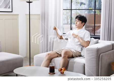 summer lifestyle, korean asian young man fanning summer lifestyle, korean asian young man fanning 105258205