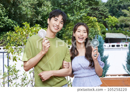 summer lifestyle, korean asian young couple enjoying electric fan outdoor 105258220