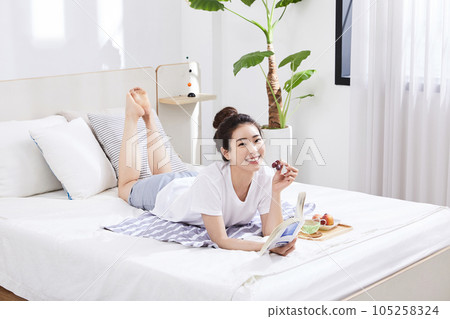 summer lifestyle, korean asian young woman with bed and fruit summer lifestyle, korean asian young woman with bed and fruit 105258324
