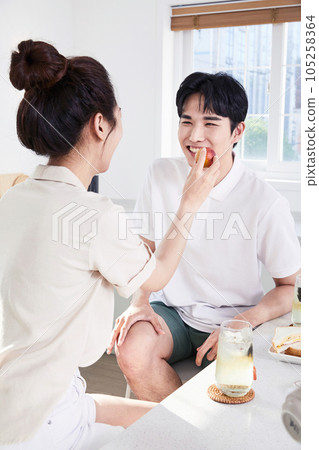 summer lifestyle, korean asian young couple feeding each other fruit 105258364