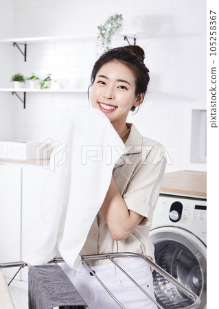 summer lifestyle, korean asian young woman smelling laundry 105258367