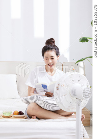 summer lifestyle, korean asian young woman with bed and book summer lifestyle, korean asian young woman with bed and book 105258379