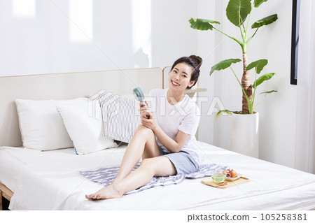 summer lifestyle, korean asian young woman with bed and fan summer lifestyle, korean asian young woman with bed and fan 105258381