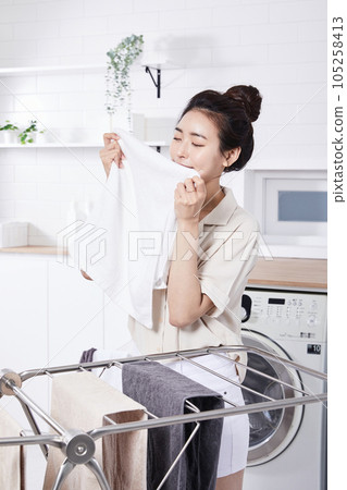 summer lifestyle, korean asian young woman smelling laundry 105258413