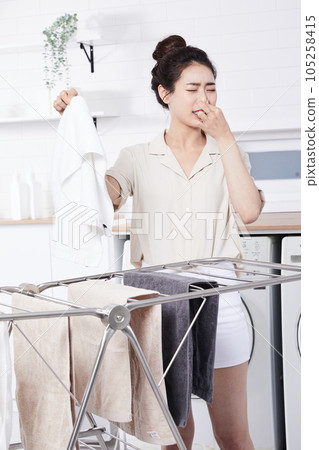 summer lifestyle, korean asian young woman concerned about the smell of laundry 105258415