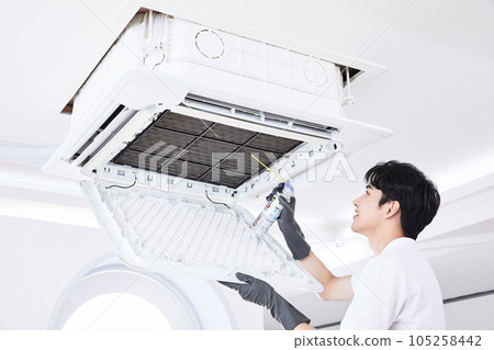 summer lifestyle, korean asian young man cleaning the air conditioner 105258442