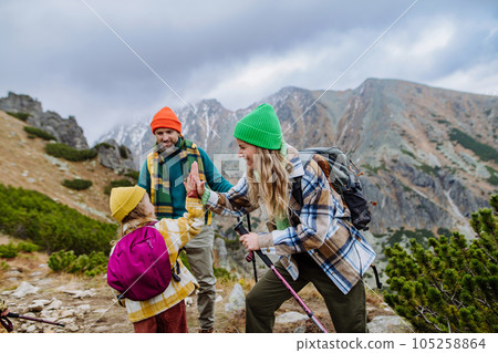 Happy family hiking together in autumn mountains. Happy family hiking together in autumn mountains. 105258864