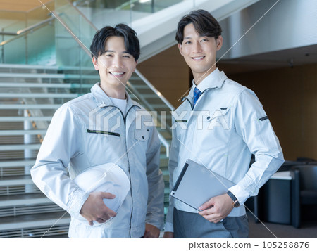 Portrait of two young male staff in work clothes Portrait of two young male staff in work clothes 105258876