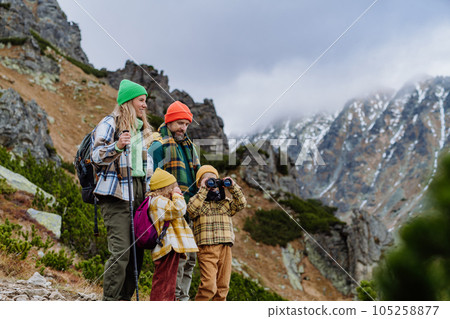 Happy family hiking together in autumn mountains. 105258877