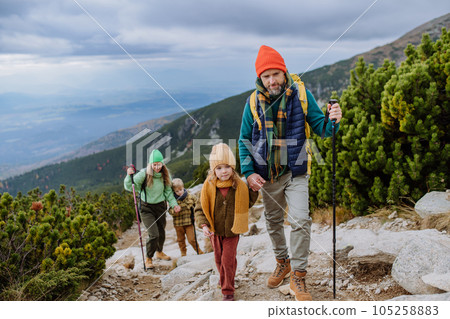 Happy family hiking together in autumn mountains. 105258883