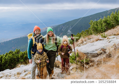Happy family hiking together in autumn mountains. 105258884