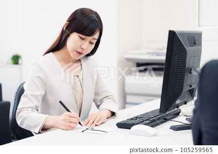 A woman preparing for a funeral at a company A woman preparing for a funeral at a company 105259565