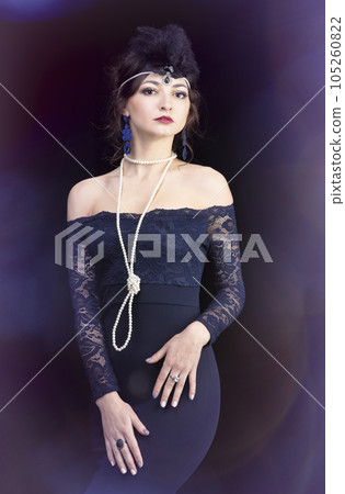 Retro woman portrait. Luxurious lady in a blue dress in the style of the 20s or 30s. 105260822