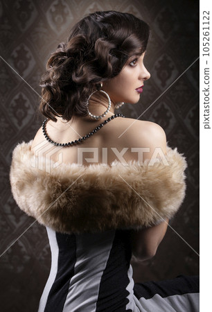 Retro woman portrait. Vintage photo of 20s or 30s style woman in furs. Old fashionable makeup and Finger Wave hairstyle. Retro woman portrait. Vintage photo of 20s or 30s style woman in furs. Old fashionable makeup and Finger Wave hairstyle. 105261122