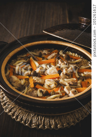 Chicken and carrot rice cooked in a clay pot Chicken and carrot rice cooked in a clay pot 105261617