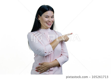 Portrait of happy korean woman pointing at copy space. Isolated on white background. 105261713