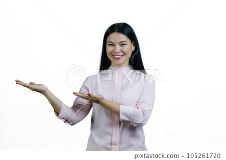 Portrait of a young asian woman presenting copy space. Isolated on white background. Portrait of a young asian woman presenting copy space. Isolated on white background. 105261720