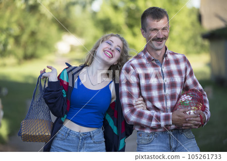 Funny village couple man and woman laughing cheerfully. 105261733