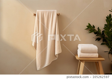 Bath towel hanging on the wall, chair with towel Bath towel hanging on the wall, chair with towel 105262597