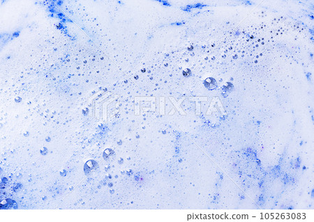 Foam of blue bath bomb dissolved in water. Soap sud background. Abstract soap foam texture. Foam of blue bath bomb dissolved in water. Soap sud background. Abstract soap foam texture. 105263083
