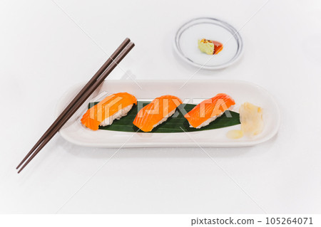 Salmon shushi roll and wasabi shoyu sauce with chopsticks. 105264071