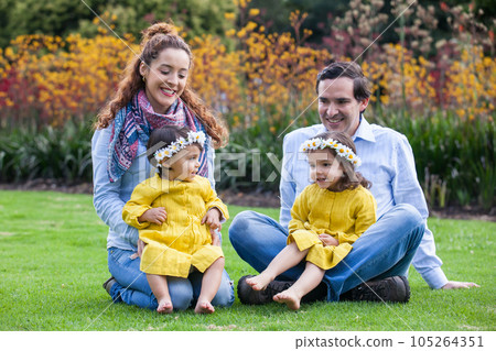 Family of four having fun outdoors in a beautiful sunny day at the park. Happiness concept. Family concept. 105264351