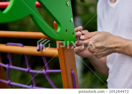 Dad collects wooden home sports complex outdoor. 105264472